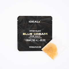 Black package of Blue Dream 83.33% THCa Dab Wax with amber concentrate visible