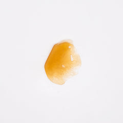 Drop of honey-like liquid on surface of Northern Lights CBD Dab Wax 1g