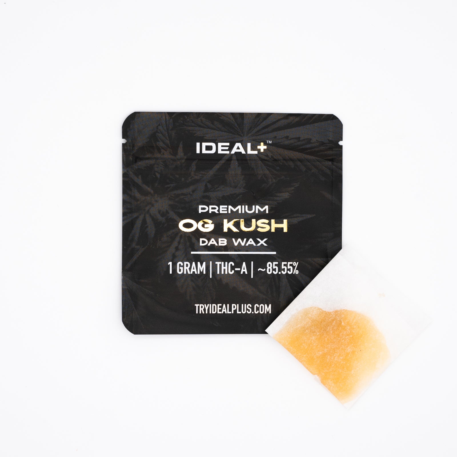 Black cannabis concentrate packaging next to amber OG Kush 85.55% THCa dab wax sample