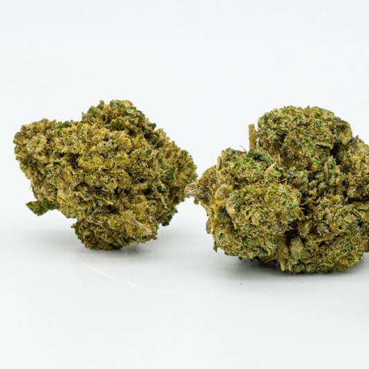 Two dense Sour RNA Delta-8 Flower buds covered in trichomes and green foliage