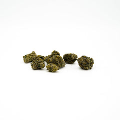 Dried cannabis buds scattered, showcasing Super Sonic THCA Flower sativa-dominant hybrid